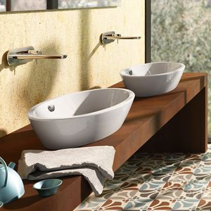 lavabo sobre encimera / ovalado / de cerámica / moderno