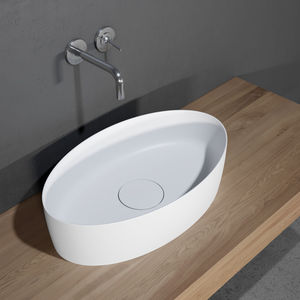 lavabo sobre encimera / ovalado / de cerámica / contemporáneo