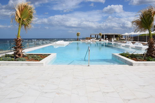 Piscina de chapa - CUSTOM BUILT - Tilestone Pools one piece tiled pools - infinita / de exterior / para el sector profesional