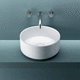 lavabo sobre mueble / de Corian® / redondo / sin orificio