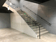escalera en L / con peldaños de hormigón / con estructura de acero / contemporánea