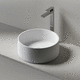 lavabo sobre mueble / de piedra / redondo / sin orificio