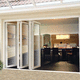 cortina de cristal corredera / plegable / con estructura de metal / con vidrio triple