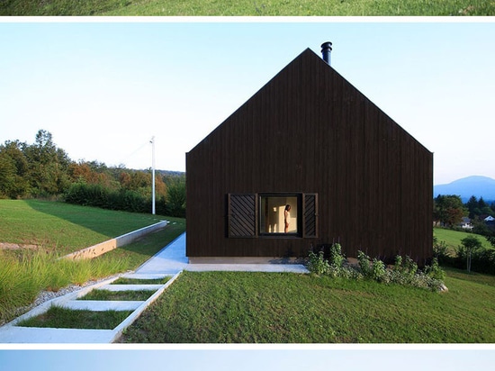 Esta pequeña casa negra se sienta en una cuesta en el campo croata